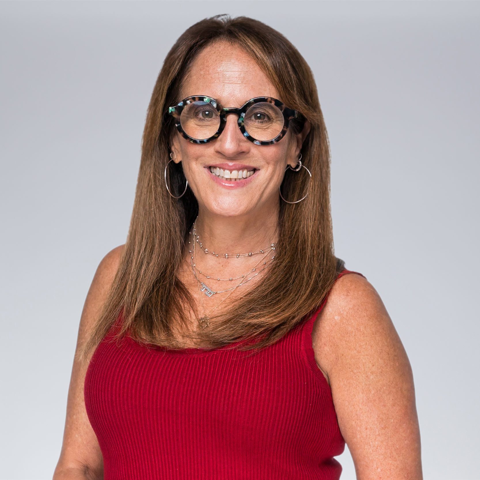 A diverse crowd of people celebrating at a concert, raising their hands and cheering.