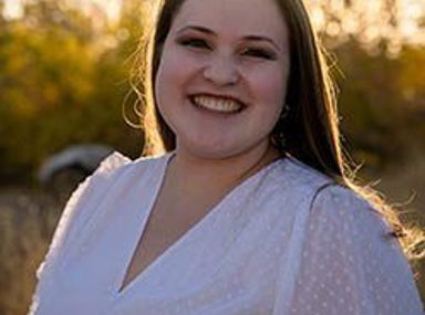 קהל מגוון של אנשים חוגג בקונצרט, מרימים את ידיהם ומריעים.