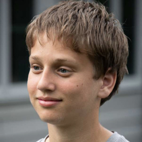 קבוצה מגוונת של צעירים קופצת מהתרגשות בגן ירוק ושופע במהלך אירוע קהילתי.