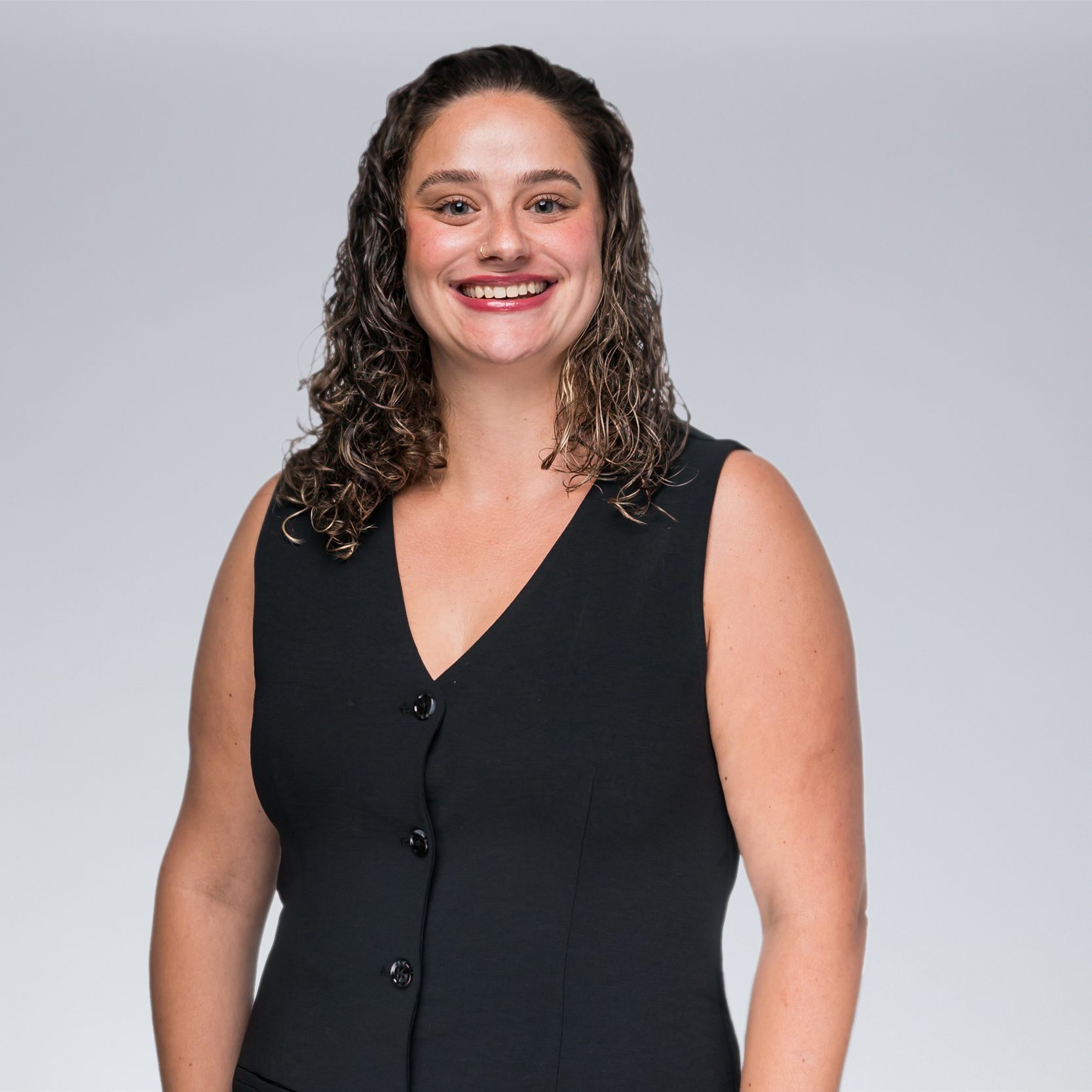A diverse crowd of people celebrating at a concert, raising their hands and cheering.